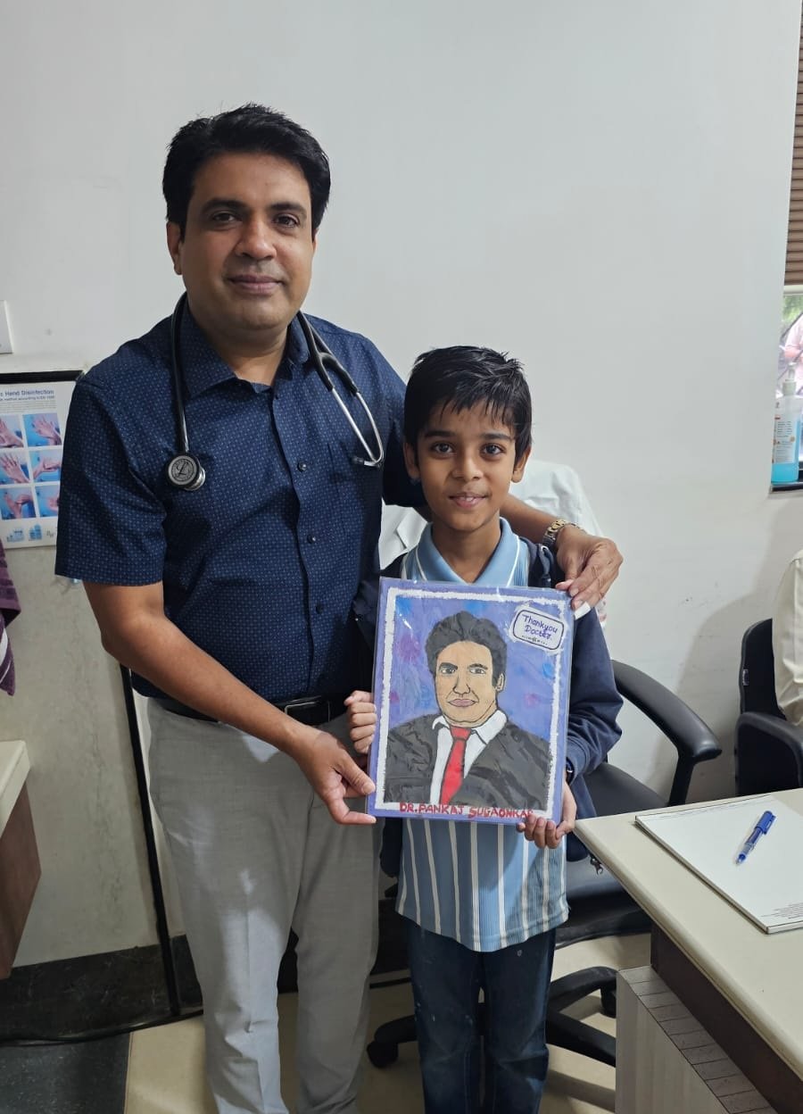 Dr. Pankaj Sugaonkar with a child at a free paediatric cardiac screening camp